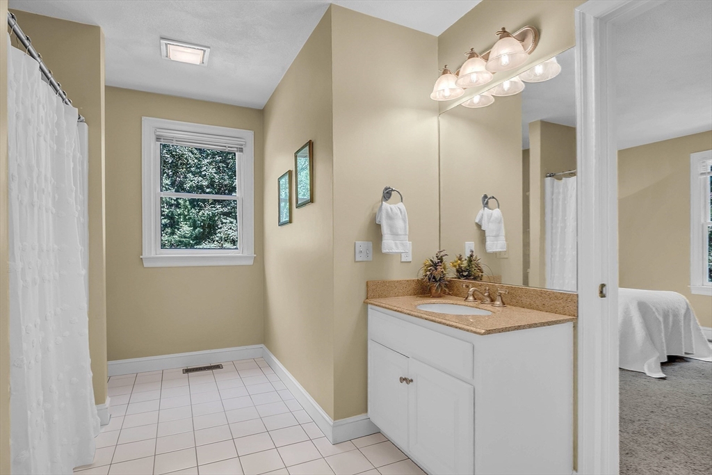 157 Lancaster Road North Andover, MA 01845 - Photo 36 of 42 a bathroom with a sink a light fixture and a mirror