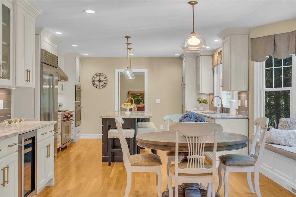 157 Lancaster Road North Andover, MA 01845 - Photo 6 of 42 a view of a dining room with furniture a chandelier and wooden floor