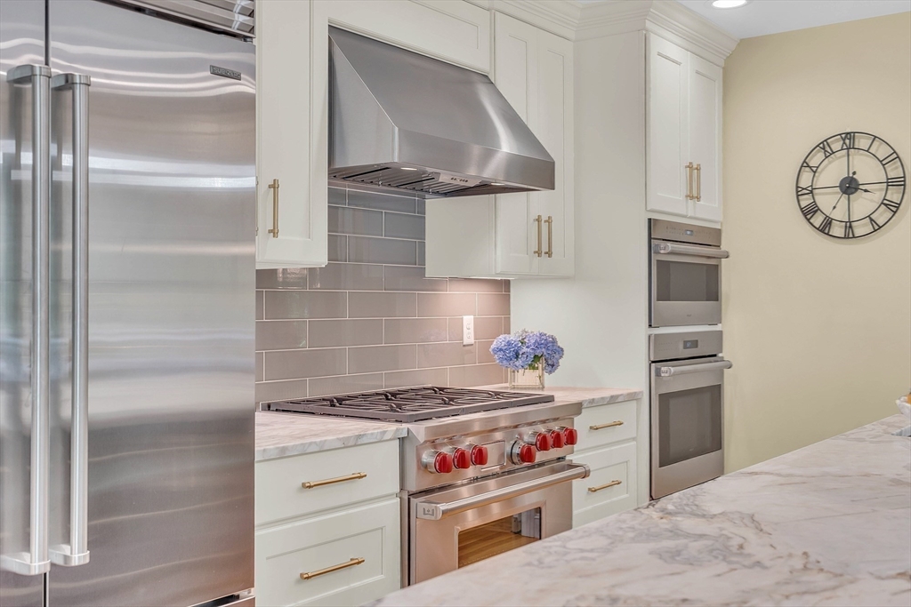 157 Lancaster Road North Andover, MA 01845 - Photo 7 of 42 a kitchen with a stove and a refrigerator