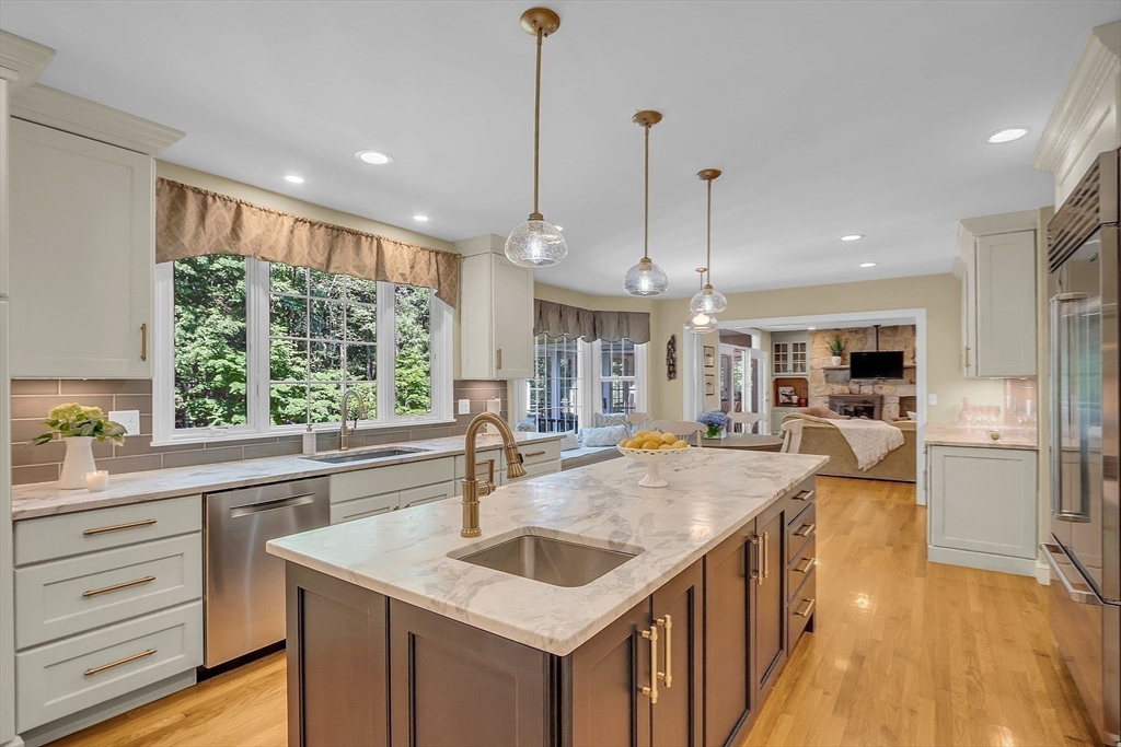 157 Lancaster Road North Andover, MA 01845 - Photo 8 of 42 a kitchen with kitchen island a large counter top appliances and cabinets