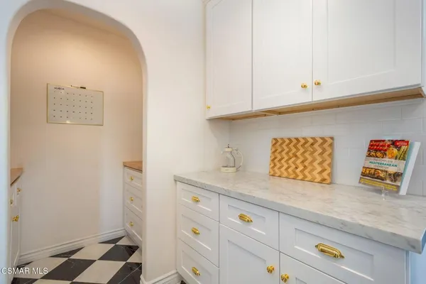 a kitchen with stainless steel appliances white cabinets and a refrigerator