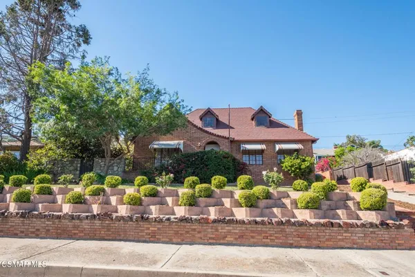 a group of people sitting in front of a house