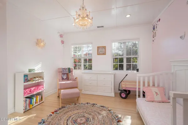 a bedroom with furniture and a chandelier