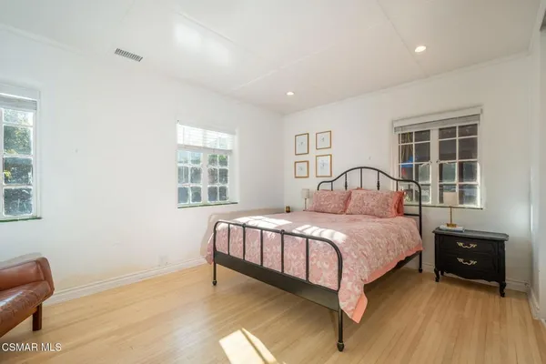 a bedroom with furniture and a flat screen tv