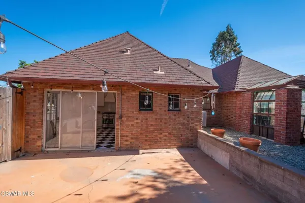 a view of a patio with wooden fence