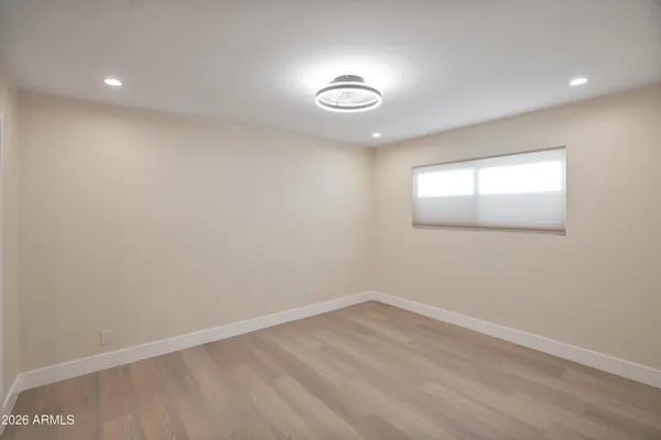 an empty room with a empty space and windows