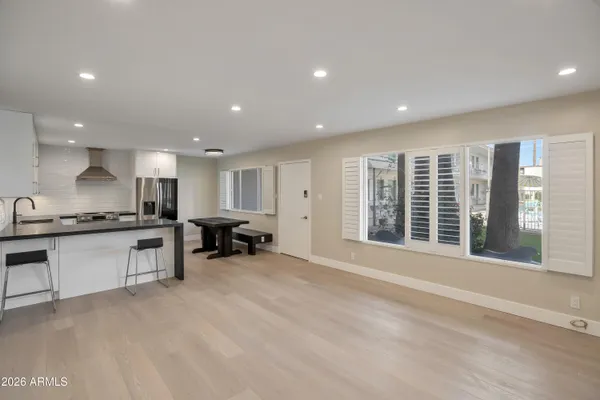 a large white kitchen with a large window