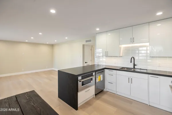 a kitchen with stainless steel appliances granite countertop a sink and cabinets