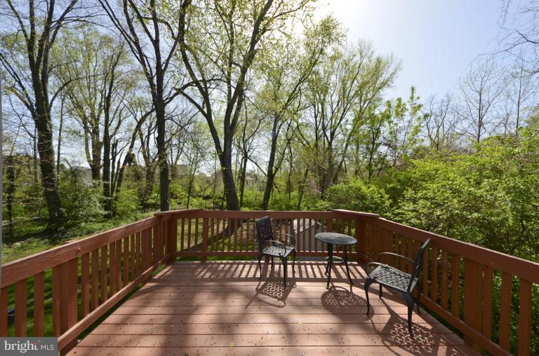 a view of a wooden deck with trees