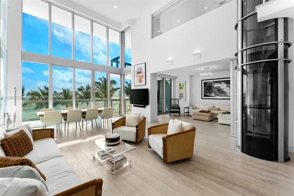 a living room with furniture large window and flat screen tv