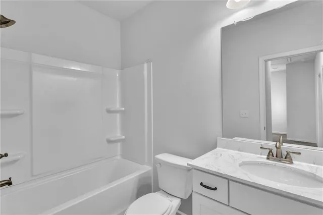 a bathroom with a sink toilet vanity and shower