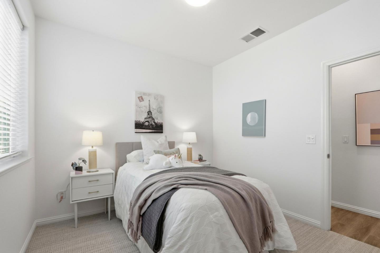 706 Fruit Ranch Loop San Jose, CA 95133 - Photo 18 of 39 a bedroom with a bed and a lamp