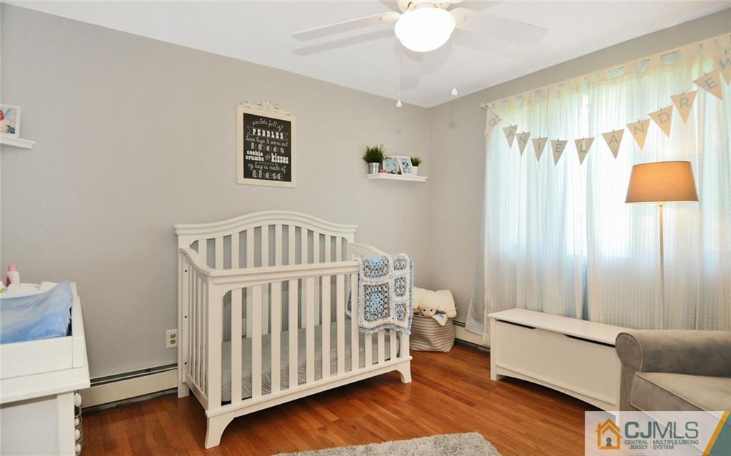156 Tunison Road New Brunswick, NJ 08901 - Photo 8 of 25 a living room with furniture and a baby crib