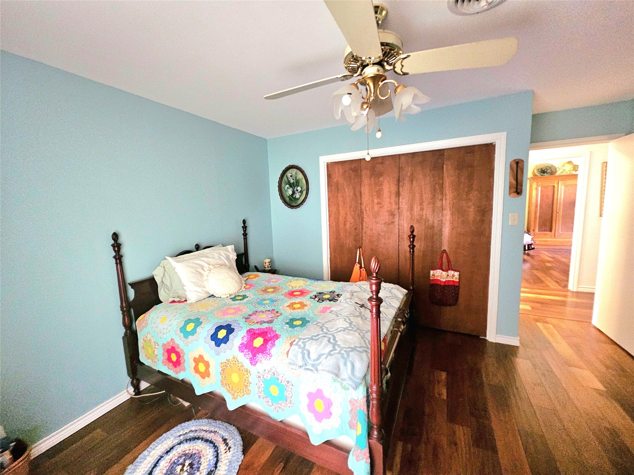 117 Laughlin Road Eagle Lake, TX 77434 - Photo 23 of 46 a bedroom with a bed and a chandelier