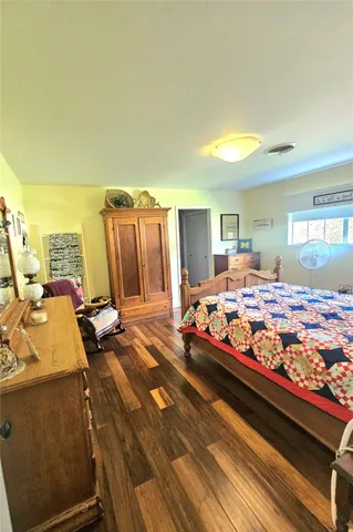 a bedroom with bed and glass door