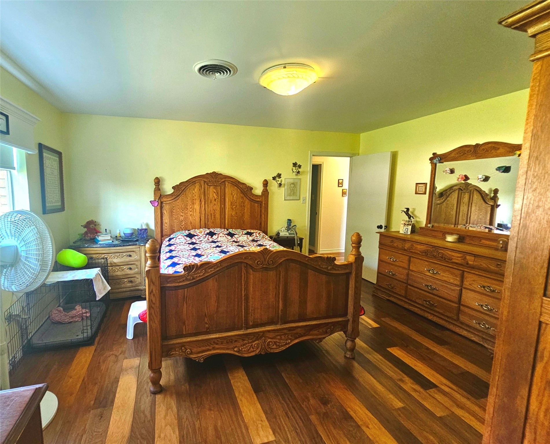 117 Laughlin Road Eagle Lake, TX 77434 - Photo 28 of 46 a bedroom with a bed and wooden floor