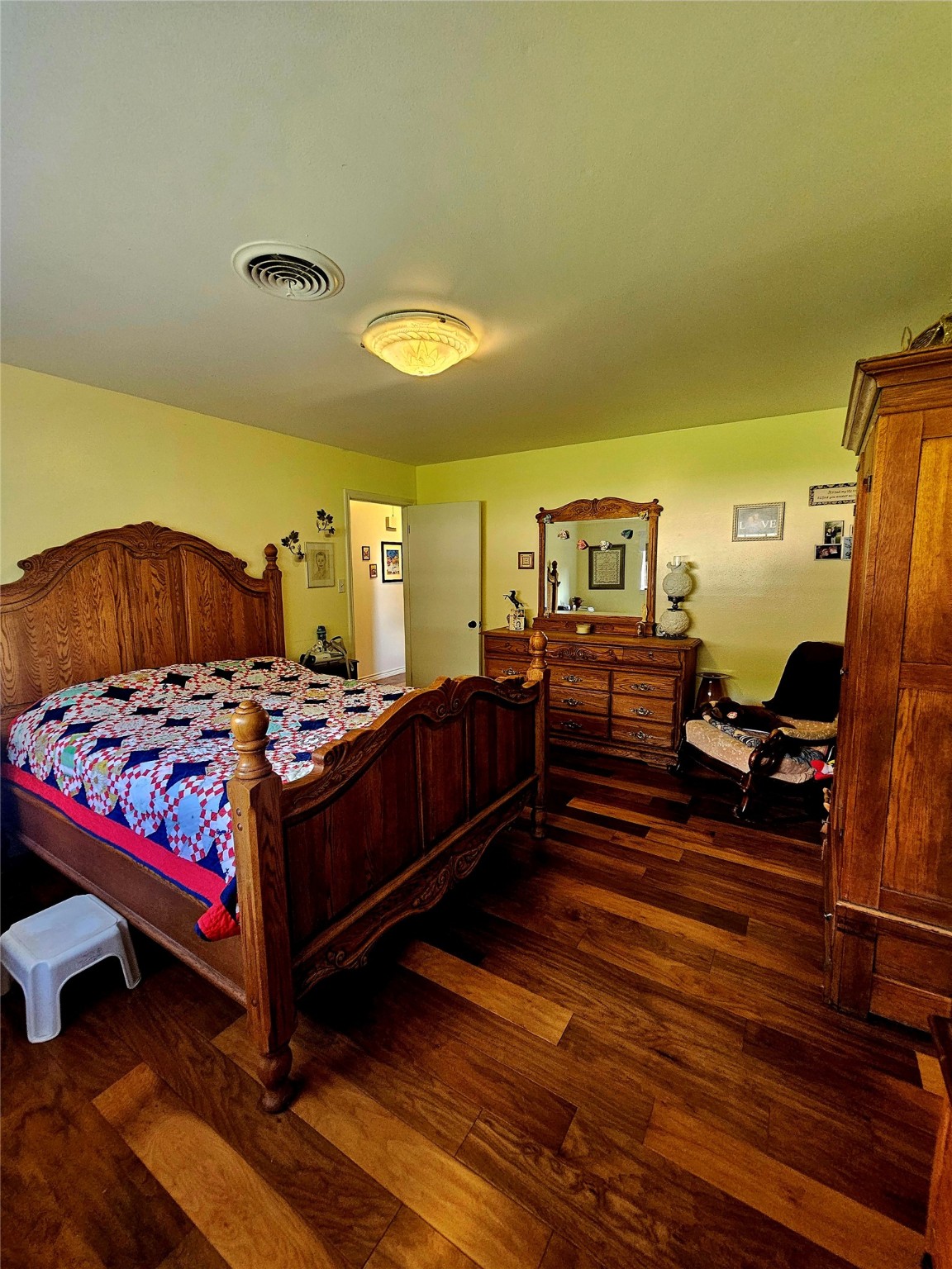 117 Laughlin Road Eagle Lake, TX 77434 - Photo 29 of 46 a bedroom with a bed and wooden floor