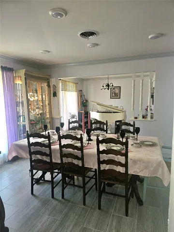 a view of a dining room with furniture and window