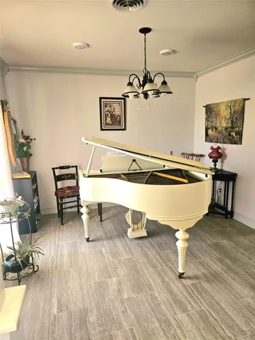 a living room with couch chairs and a wooden floor
