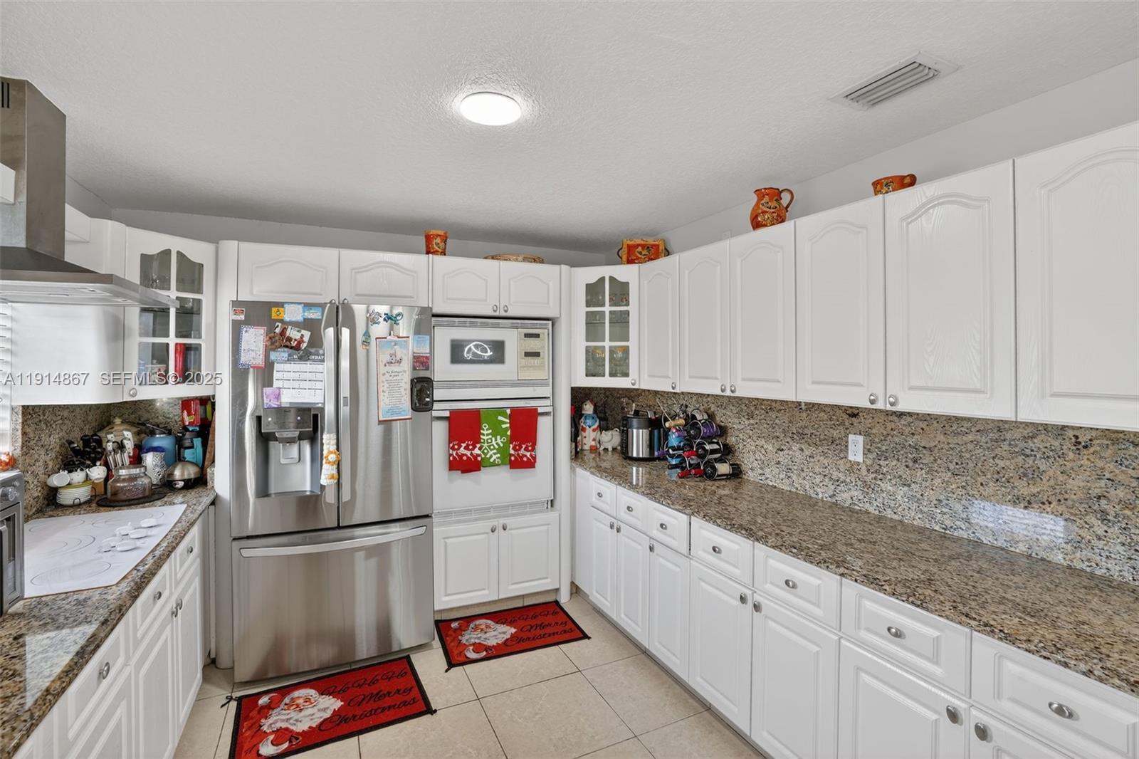 9835 Southwest 26th Terrace Miami, FL 33165 - Photo 13 of 48 a kitchen with stainless steel appliances granite countertop a refrigerator and a sink