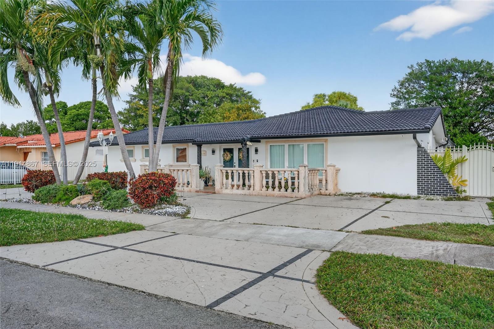 9835 Southwest 26th Terrace Miami, FL 33165 - Photo 2 of 48 a front view of a house with a garden and patio