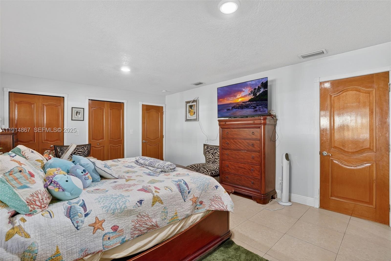 9835 Southwest 26th Terrace Miami, FL 33165 - Photo 23 of 48 a bedroom with a bed and a dresser