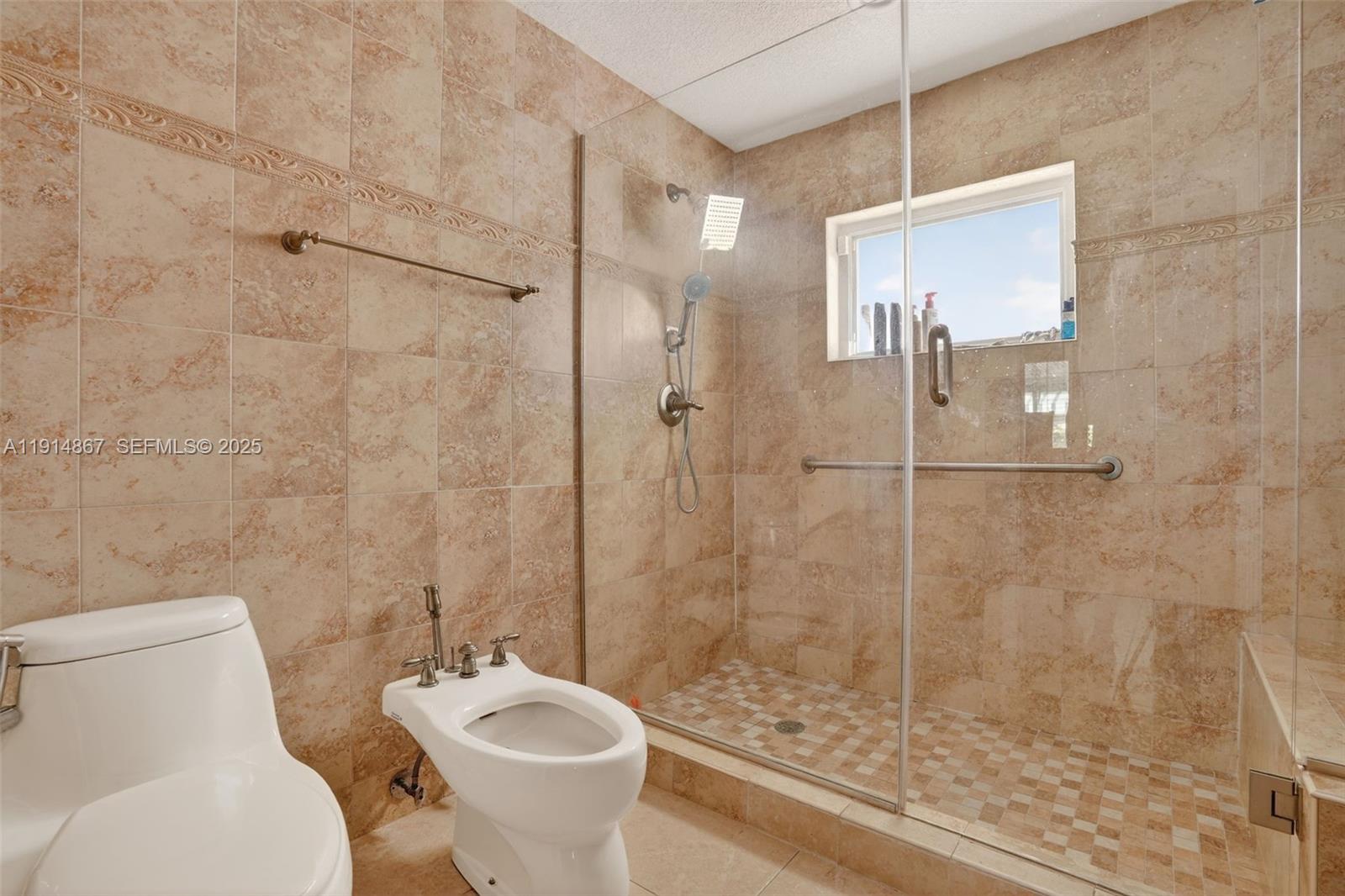 9835 Southwest 26th Terrace Miami, FL 33165 - Photo 24 of 48 a bathroom with a toilet sink and shower