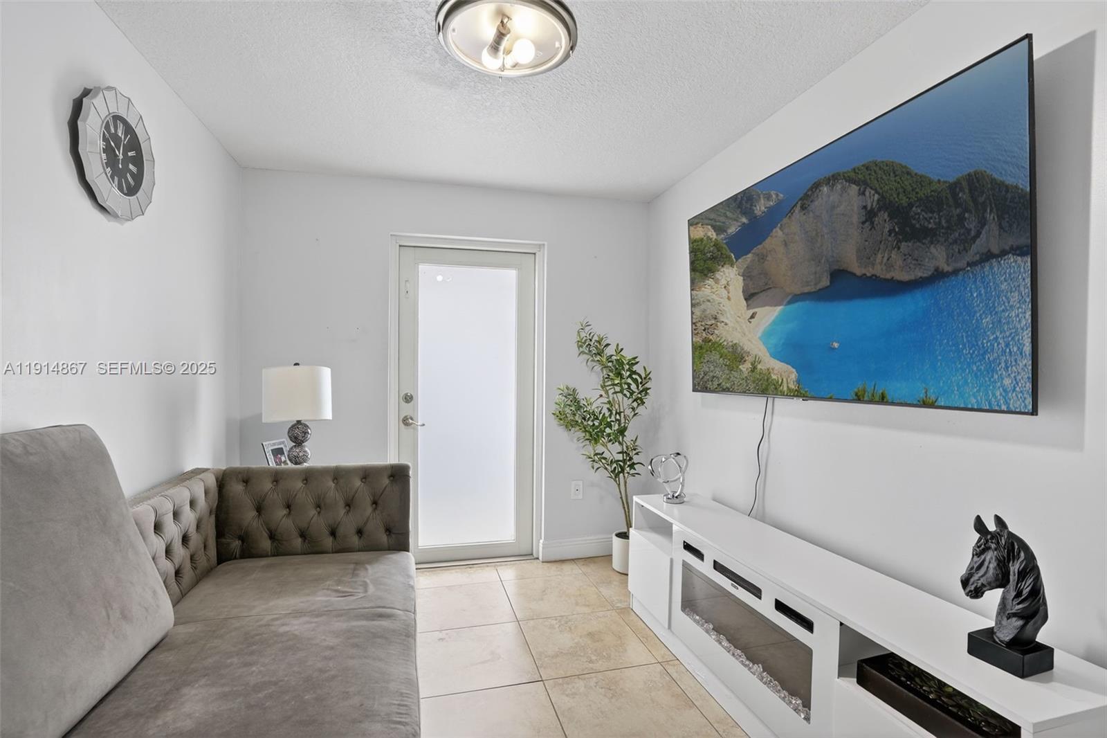 9835 Southwest 26th Terrace Miami, FL 33165 - Photo 31 of 48 a spacious bedroom with a bed and a painting on the wall