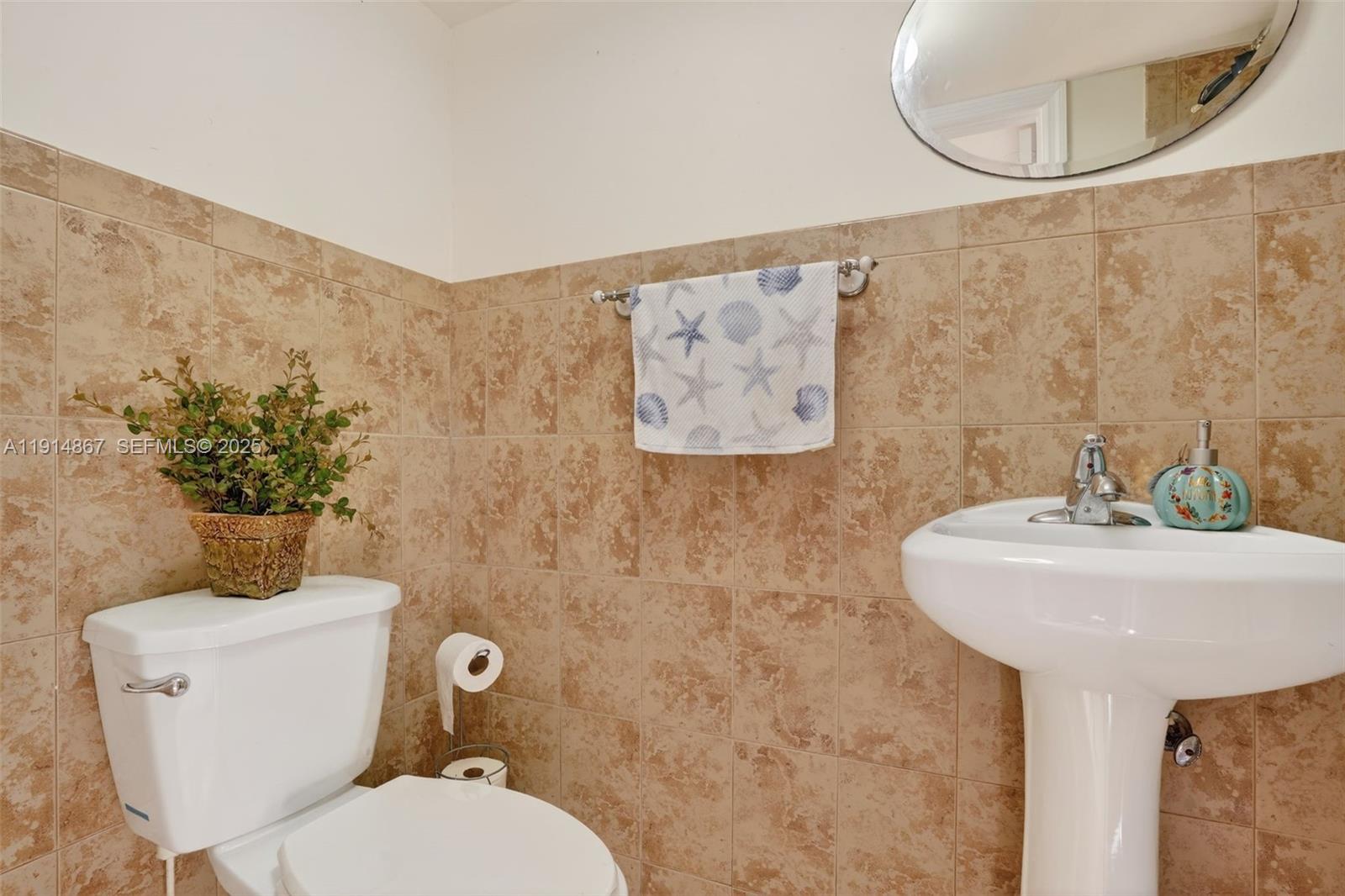 9835 Southwest 26th Terrace Miami, FL 33165 - Photo 43 of 48 a bathroom with a toilet sink and mirror