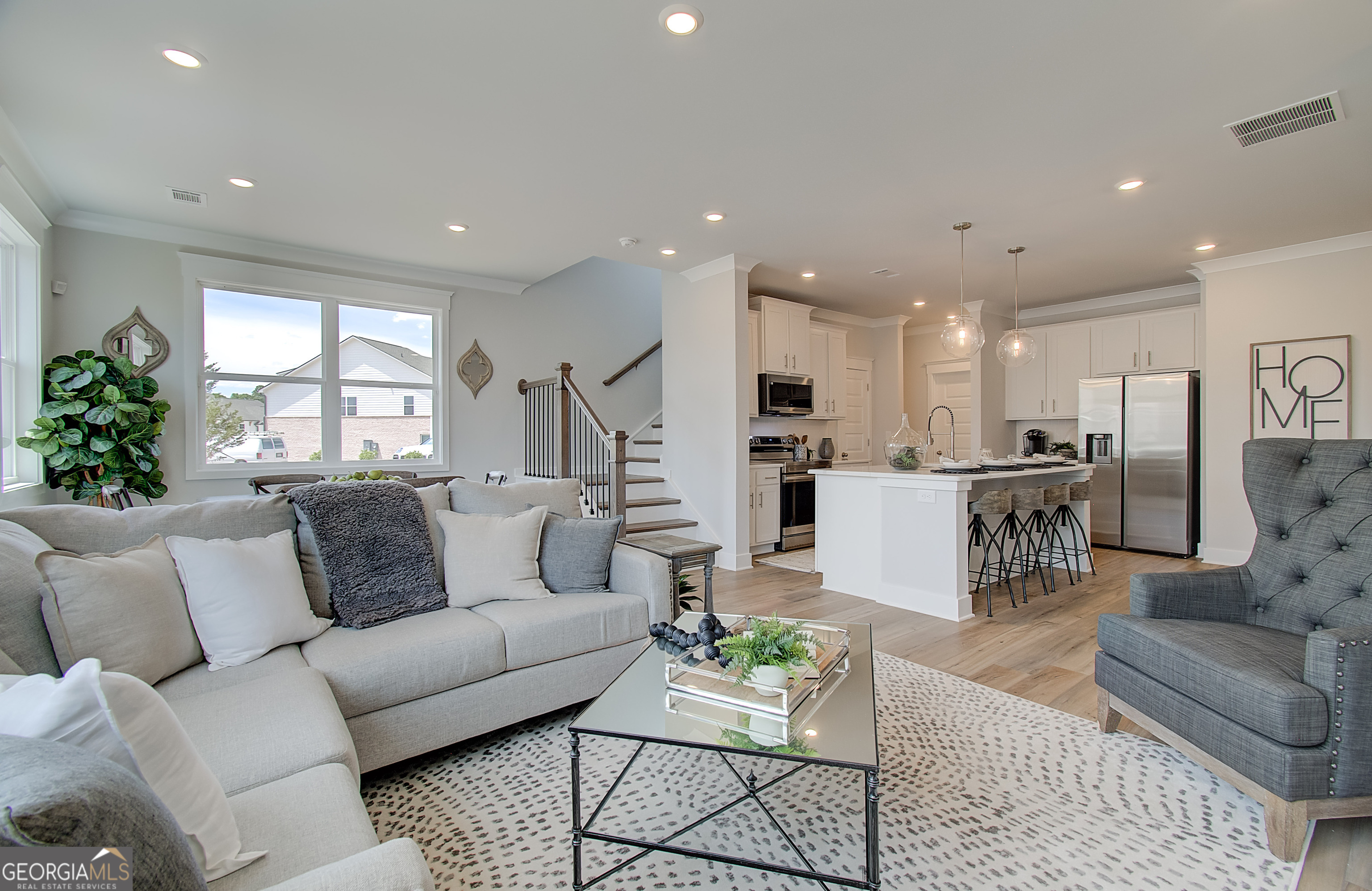 179 Depot Landing Road, Unit 27A Auburn, GA 30011 - Photo 12 of 38 a living room with furniture kitchen and a large window