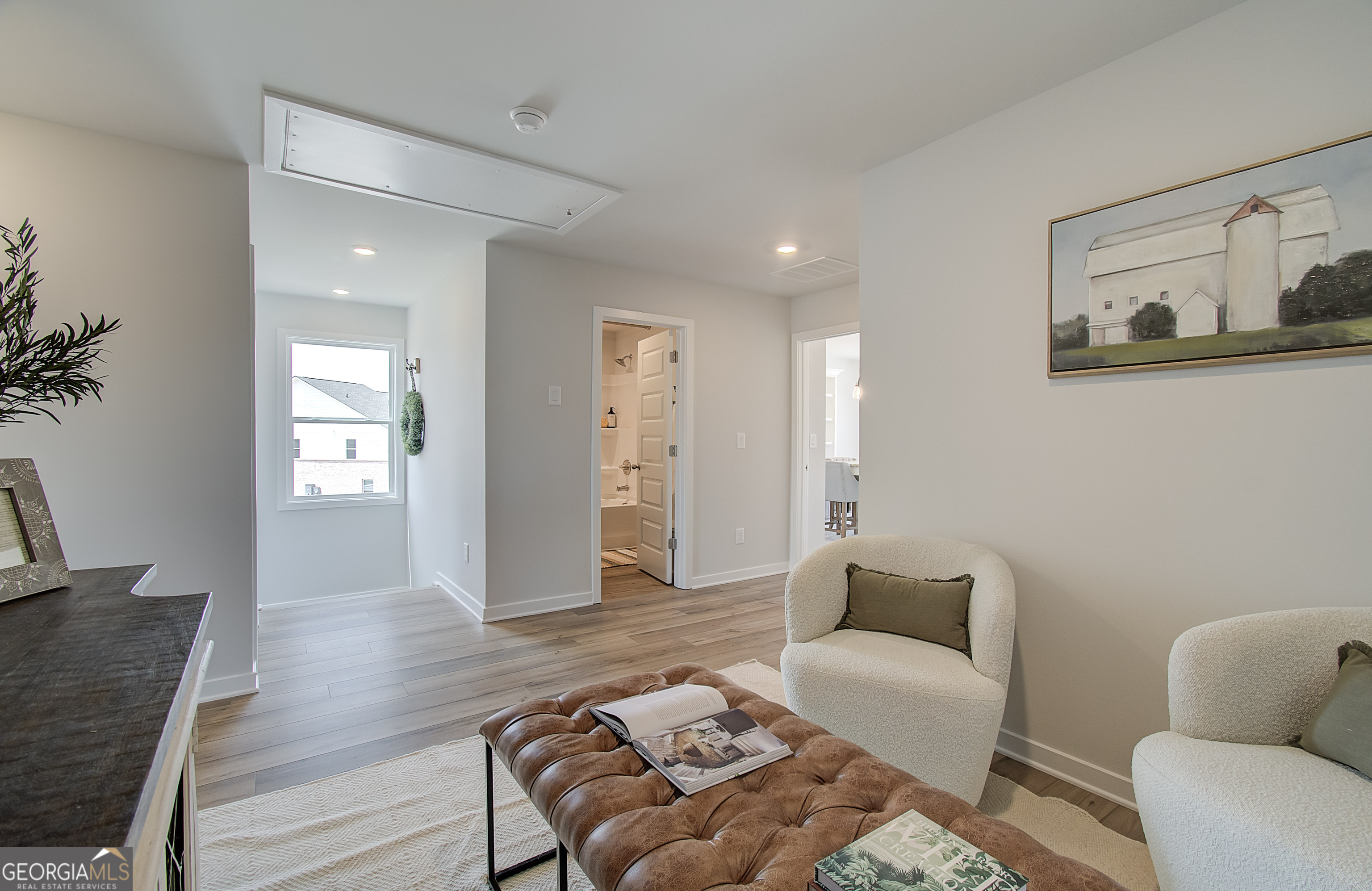 179 Depot Landing Road, Unit 27A Auburn, GA 30011 - Photo 16 of 38 a living room with furniture and wooden floor
