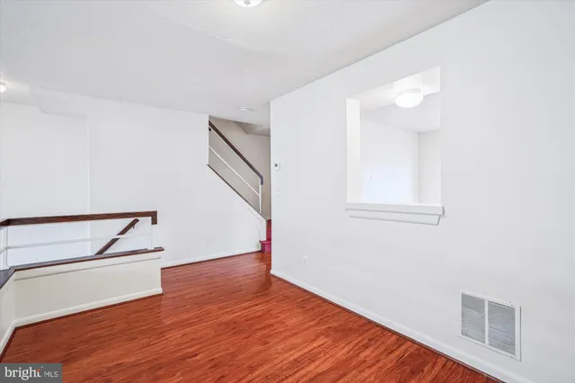 a view of room with window and hardwood floor