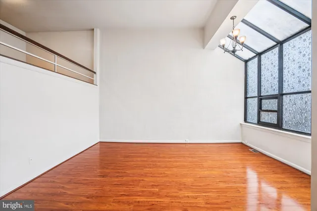 a view of front door with wooden floor and window