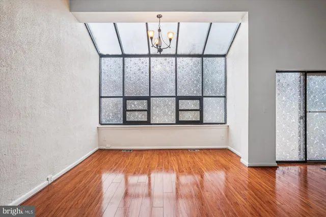 a bathroom with a granite countertop toilet sink and mirror