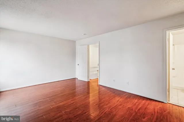a bathroom with a granite countertop toilet a sink and a bathtub