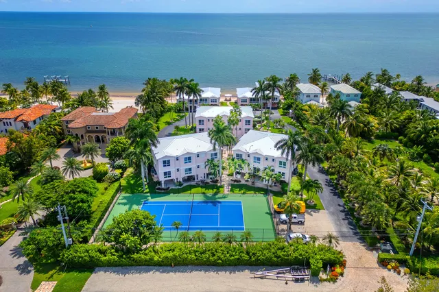 a dining room with furniture a rug and a mirror