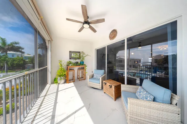 a view of a balcony with furniture