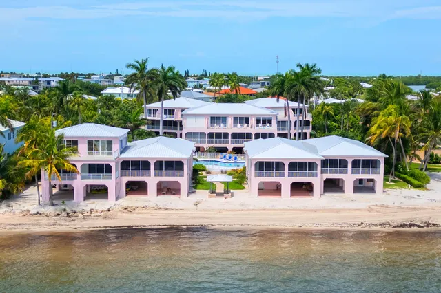 a front view of building with yard and ocean view