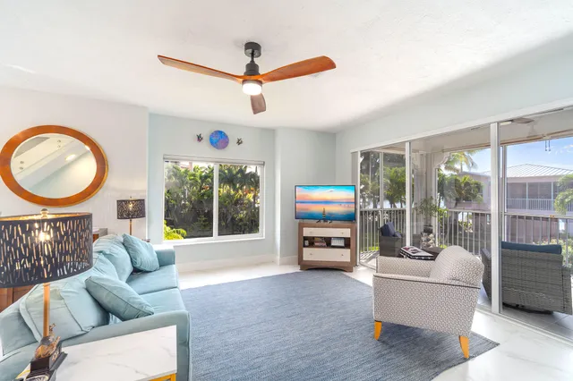 a bedroom with bed and a chandelier