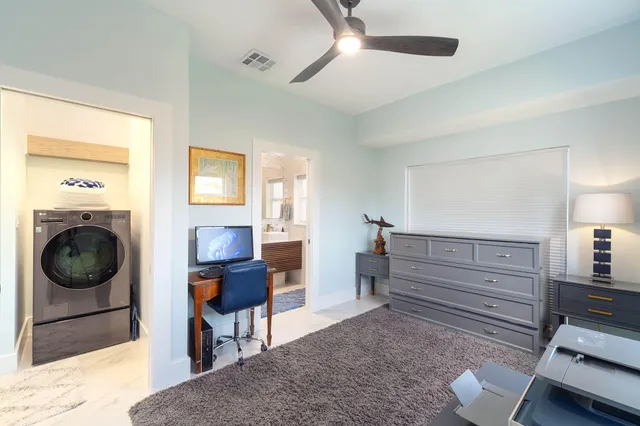 a front view of a house with a garden and swimming pool