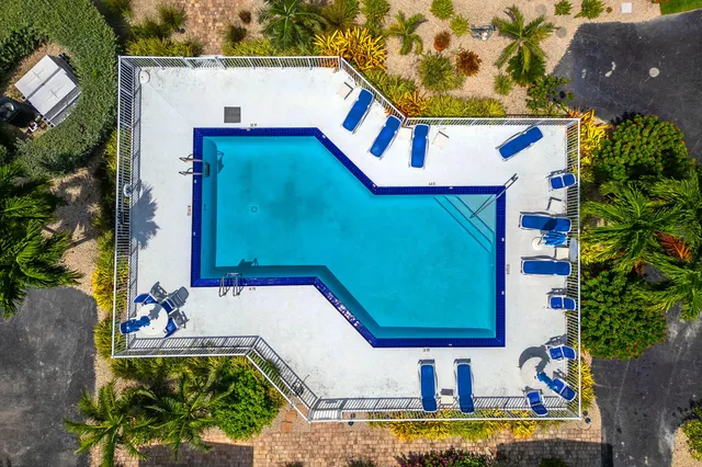an aerial view of a house with swimming pool patio and outdoor seating