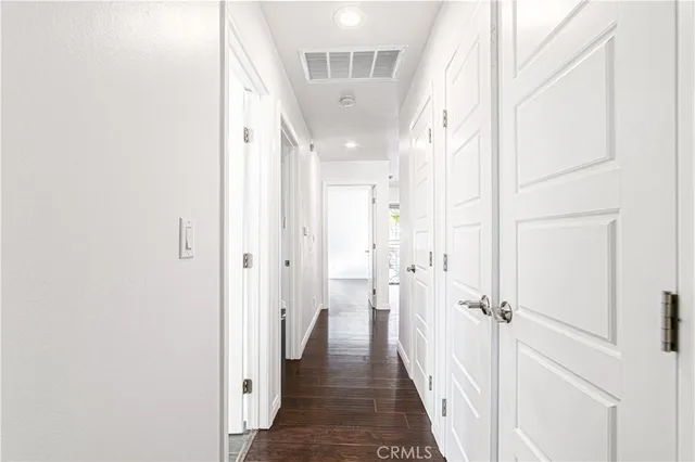 a view of a hallway with a white walls