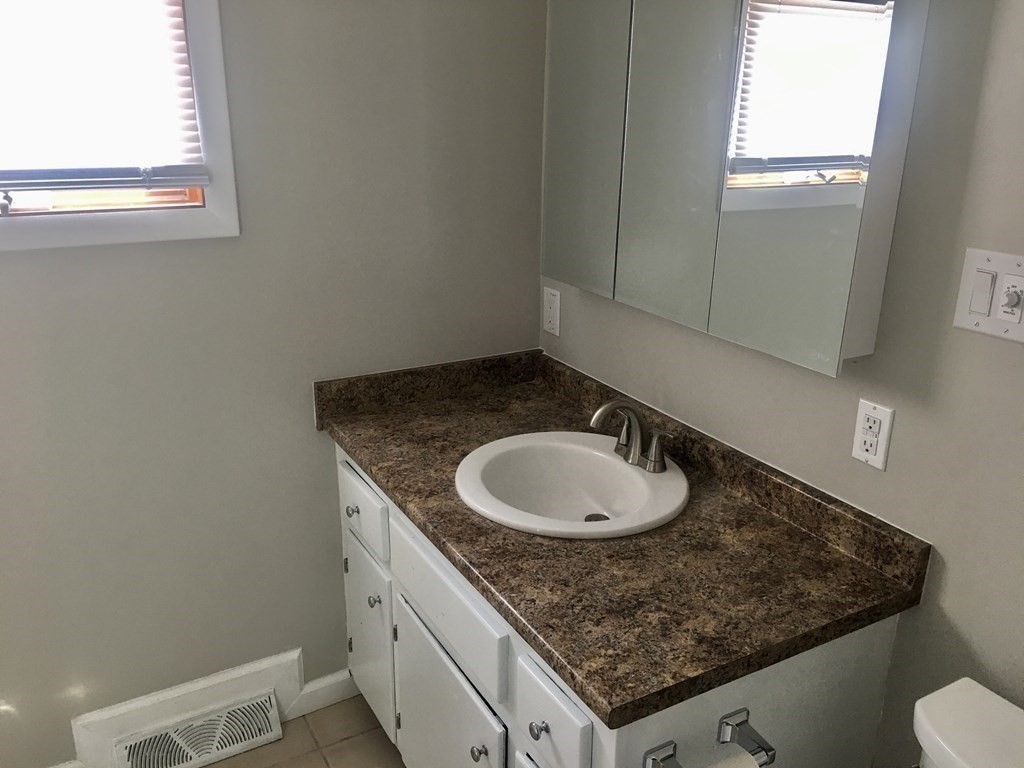 945 Tinkham Road Wilbraham, MA 01095 - Photo 11 of 26 a bathroom with a granite countertop sink and a mirror