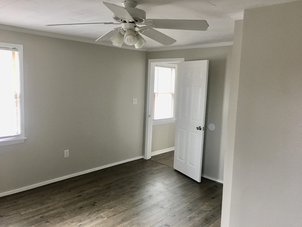 945 Tinkham Road Wilbraham, MA 01095 - Photo 14 of 26 an empty room with wooden floor fan and windows