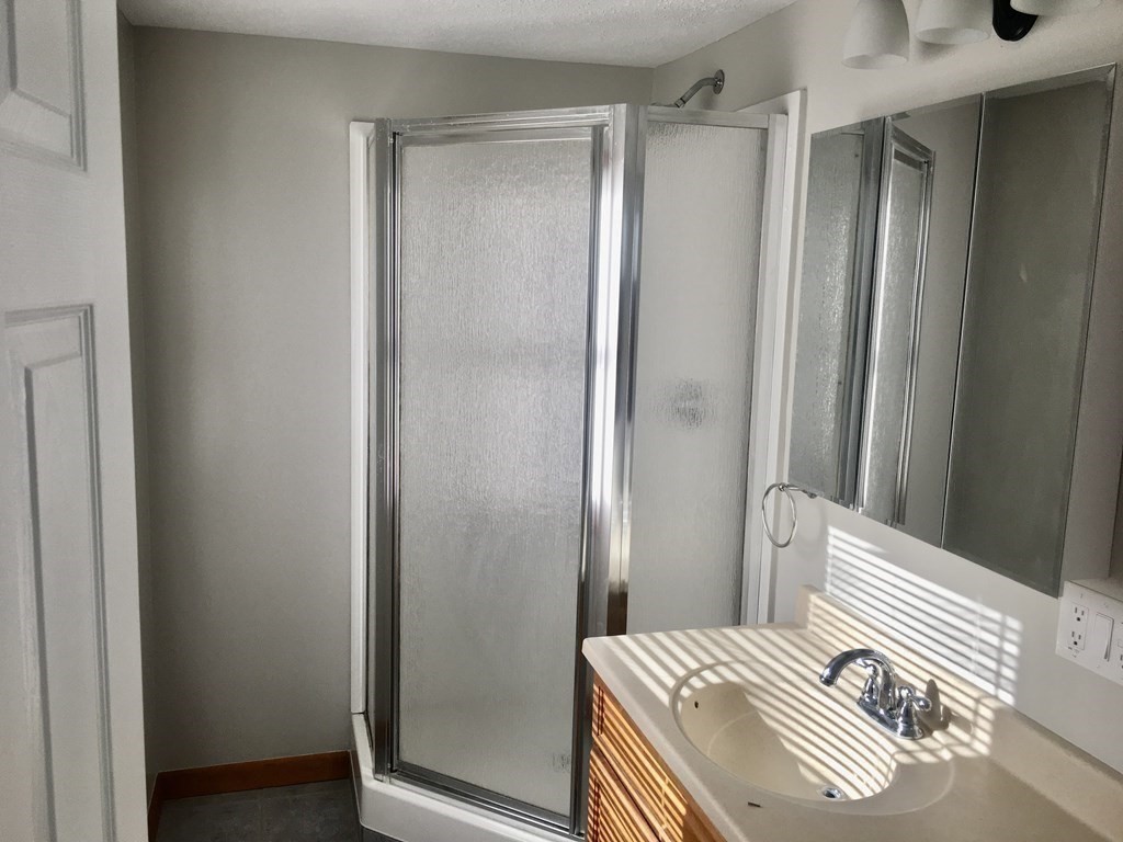 945 Tinkham Road Wilbraham, MA 01095 - Photo 16 of 26 a bedroom with a bed and a mirror