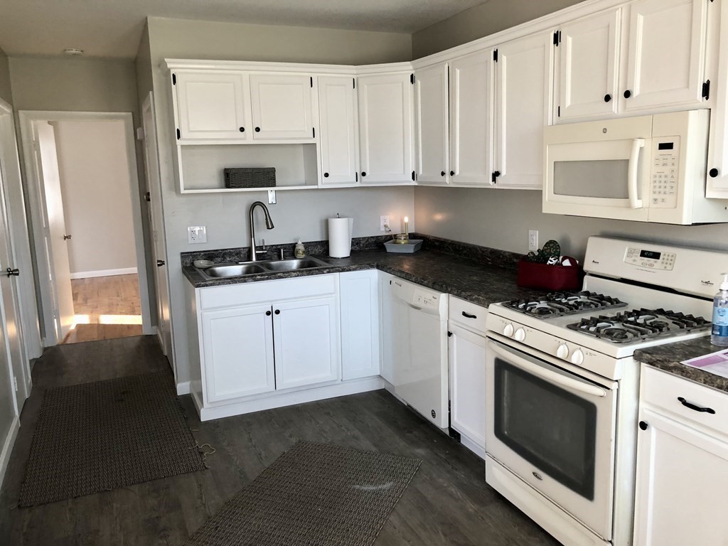 945 Tinkham Road Wilbraham, MA 01095 - Photo 2 of 26 a kitchen with granite countertop white cabinets and white appliances