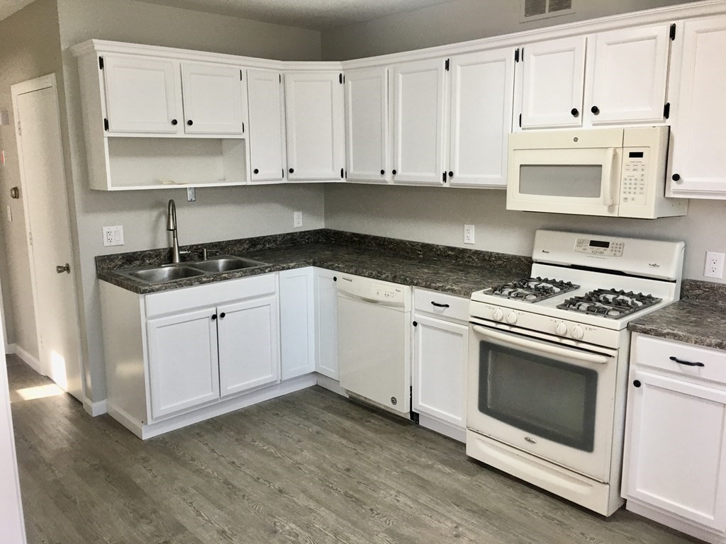 945 Tinkham Road Wilbraham, MA 01095 - Photo 3 of 26 a kitchen with granite countertop white cabinets and white appliances