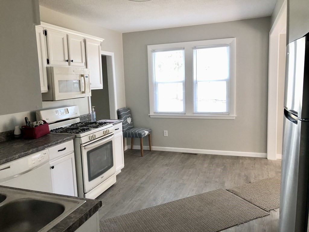 945 Tinkham Road Wilbraham, MA 01095 - Photo 4 of 26 a kitchen with granite countertop a stove and a sink