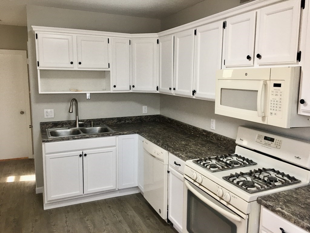 945 Tinkham Road Wilbraham, MA 01095 - Photo 5 of 26 a white kitchen with granite countertop stainless steel appliances