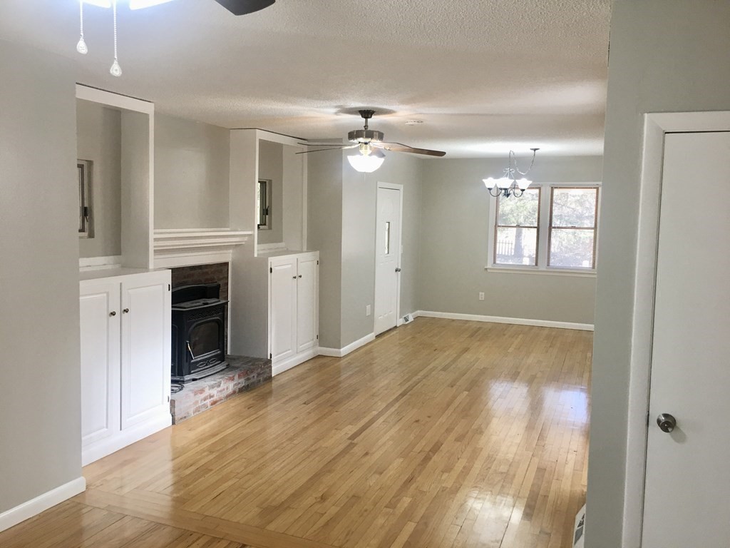 945 Tinkham Road Wilbraham, MA 01095 - Photo 7 of 26 wooden floor in an empty room with a window